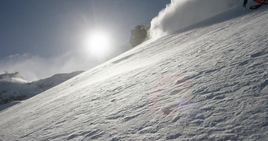 A person with a helmet and goggles skiing down a snowy slope
