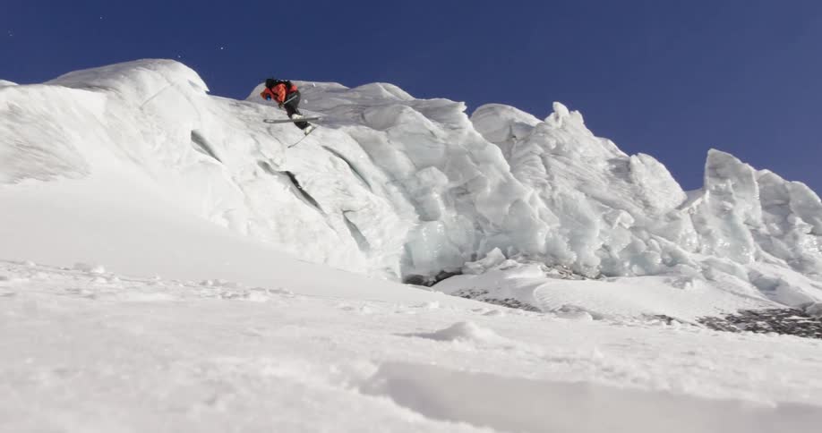 A person does a large jump while skiing