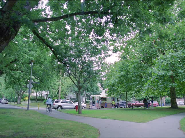 People walk and cycle in the public park with walking trails grass fields
