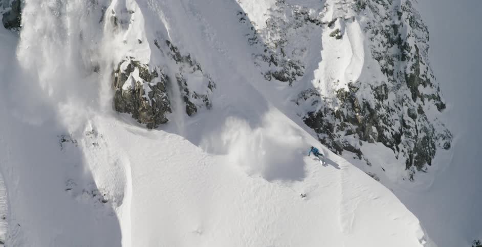 A person is skiing down a hill in winter