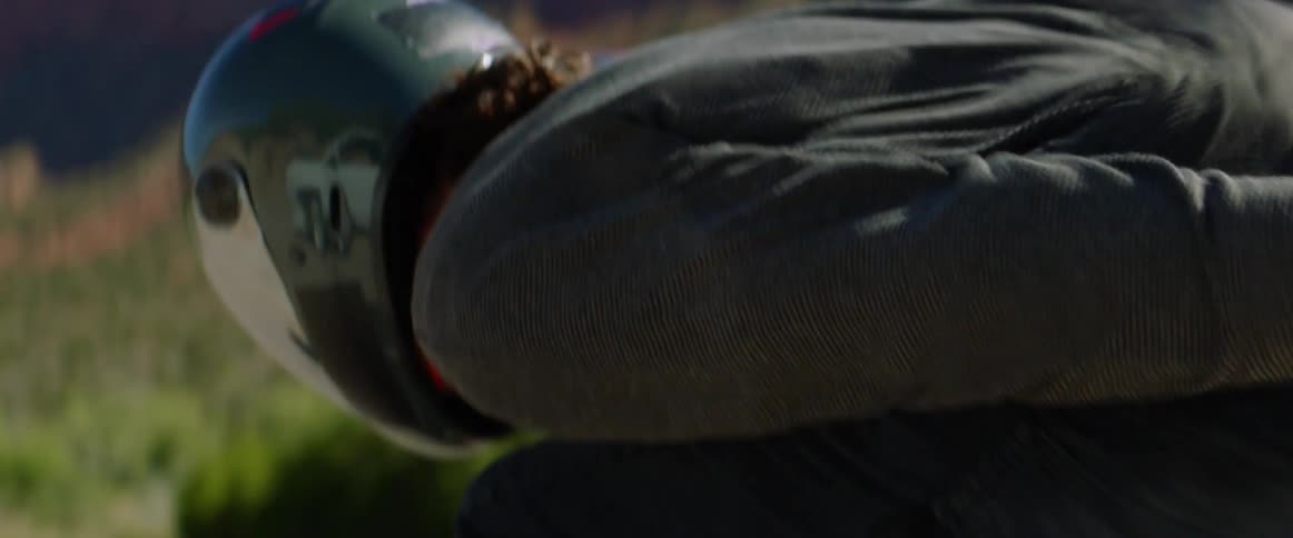 A person riding a longboard down a mountain