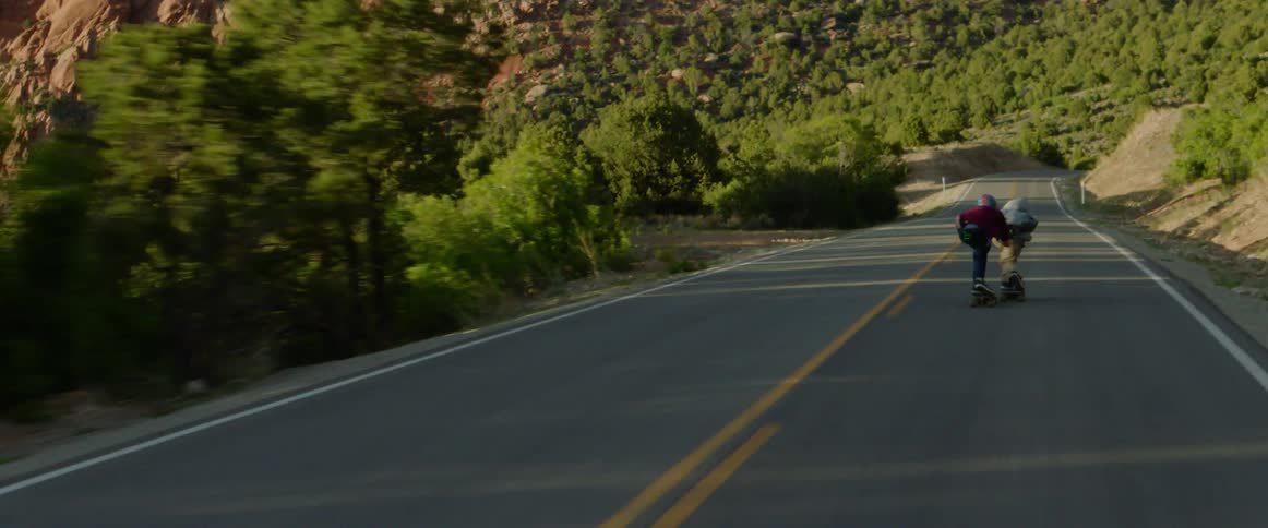 Two people racing one another on skateboards