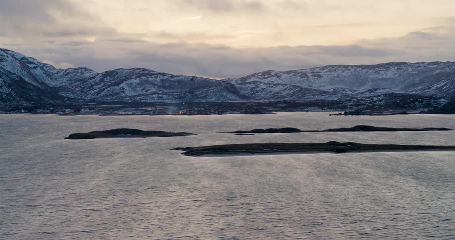 Snowy mountains and a lake in the winter time
