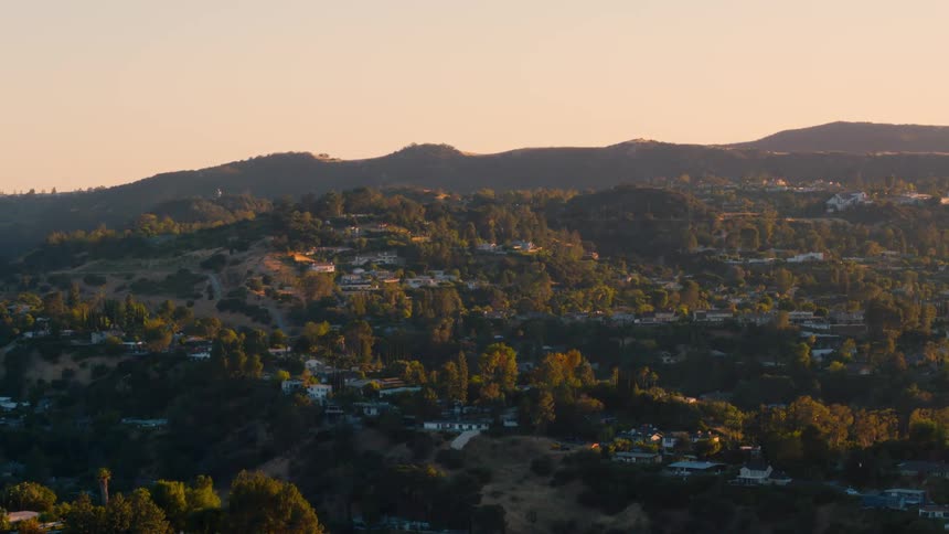 Houses and trees in a neighborhood at sunset