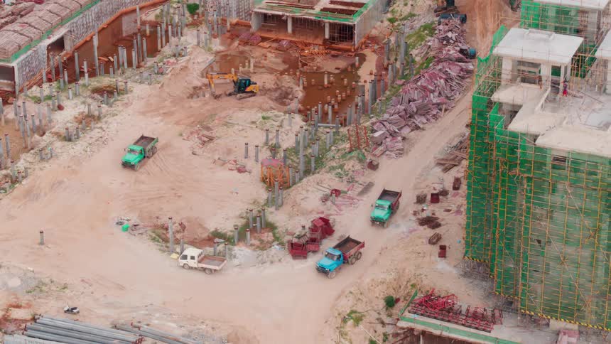 Dump trucks drive through the developing city