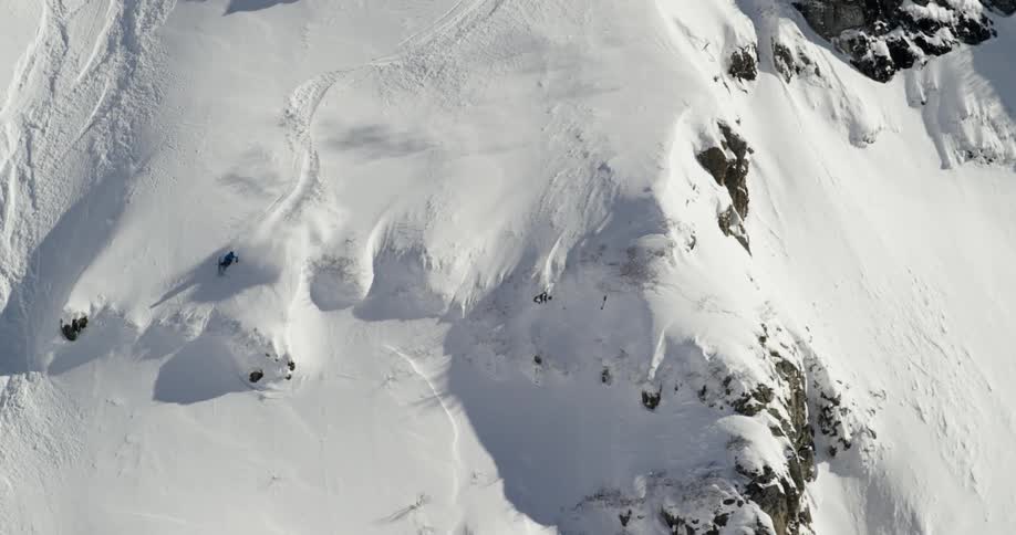 A skier skiing down a snowy mountain