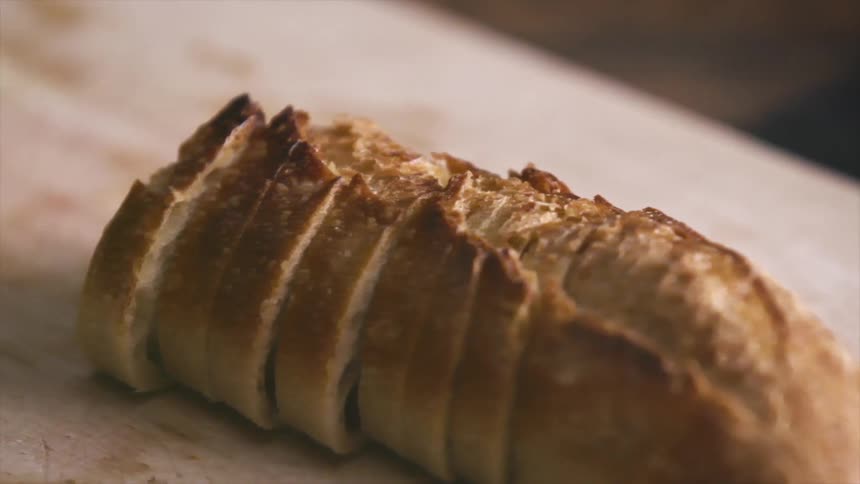 A sliced loaf of bread over a wooden cutting board