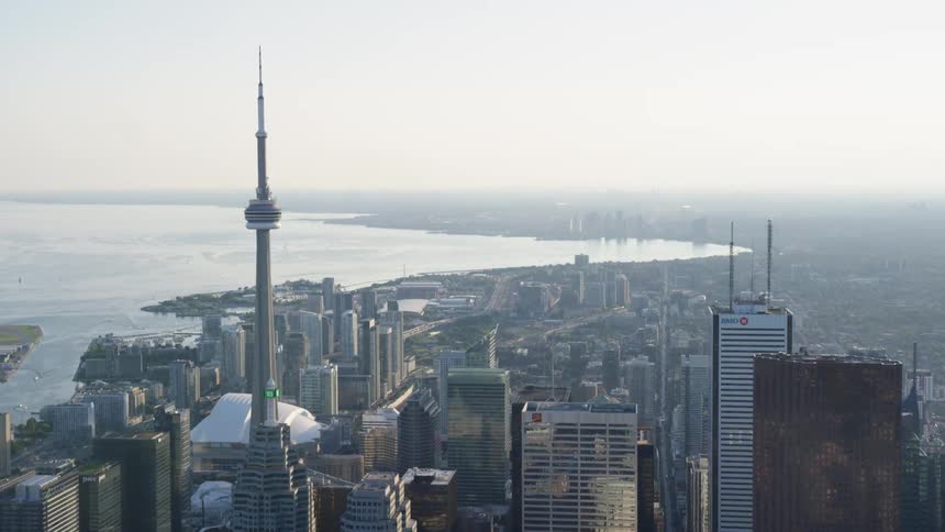 Aerial of a city scape featuring downtown Toronto's CN Tower and Roger's Center Stadium