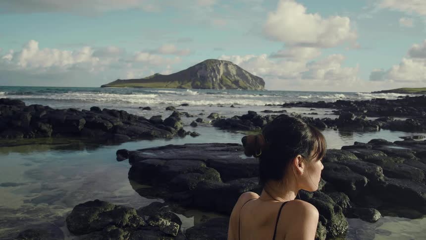 A woman is relaxing by the beach