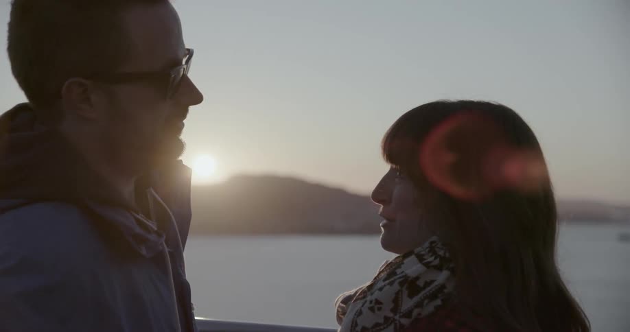 A man and woman talking at sunset