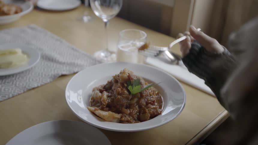 A person eats at a table