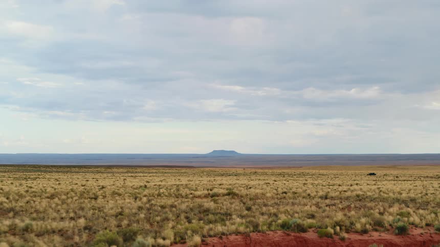 A vast shrubland under a cloudy daytime sky