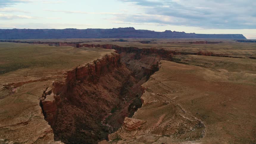 A vast winding canyon on a cloudy day