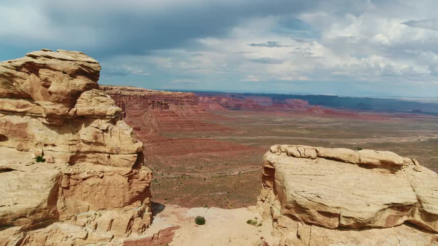 A mountain looms over a vast badland on a cloudy day