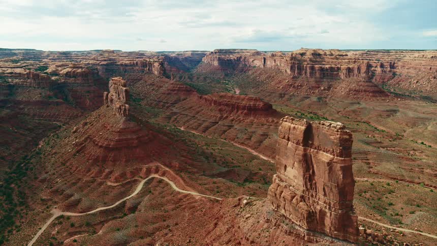 An aerial view of tall rock formations in a remote desert canyon