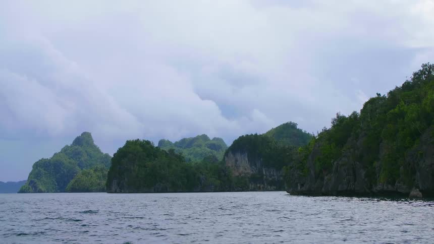 Ocean water rippling around islands covered in trees and vegetation