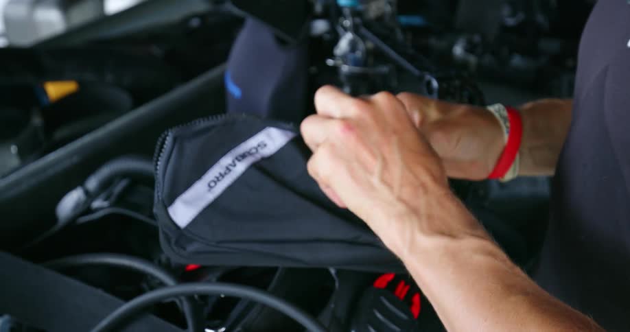 A man packs up and stores some gear intended for scuba diving
