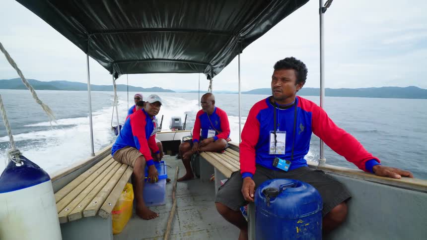 Rangers on a patrol boat as it drives across the ocean
