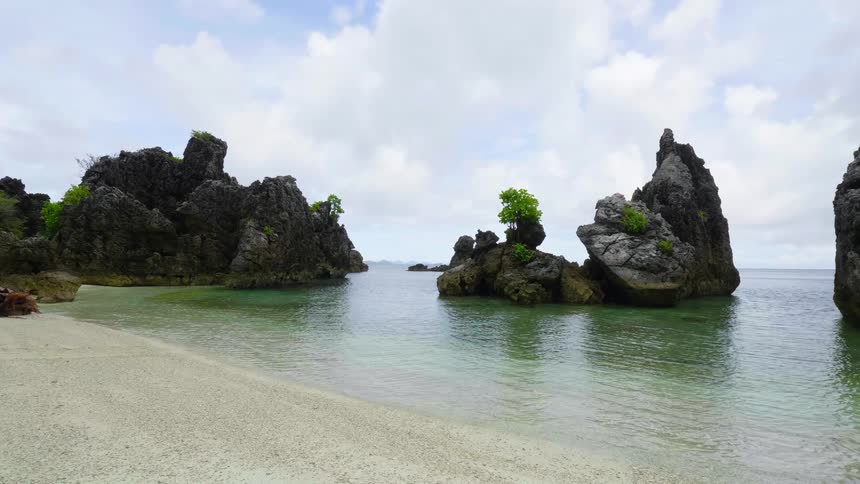 A view of some large rocks off the shore in the ocean