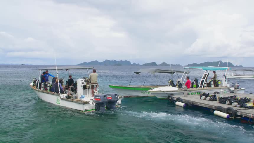 A group of people heading out on a boat from a dock