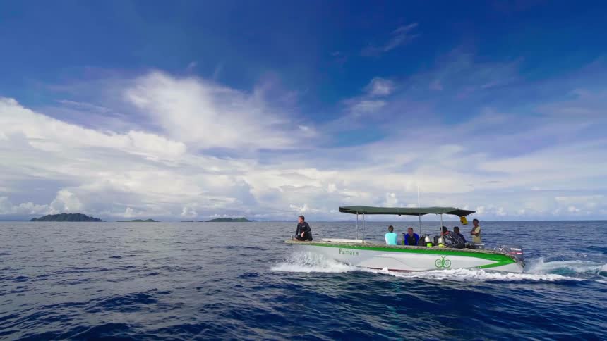 People are riding in a boat in the ocean