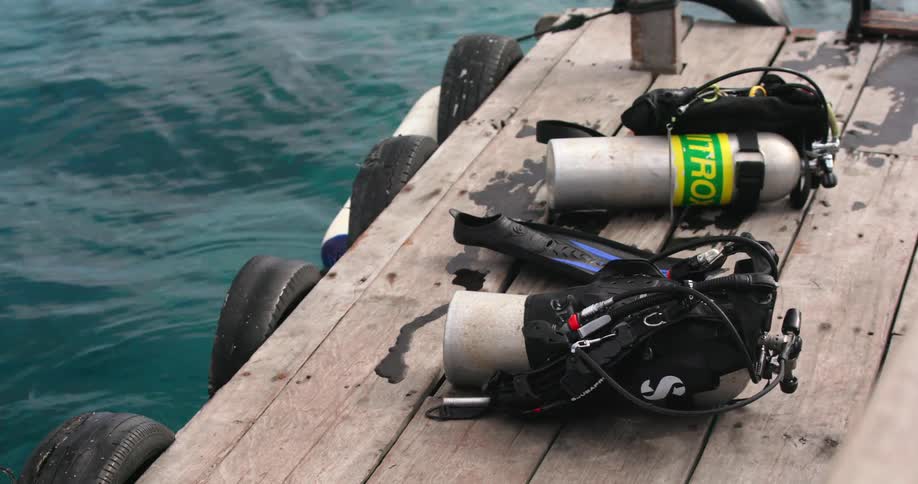 Scuba tanks on a dock in the water