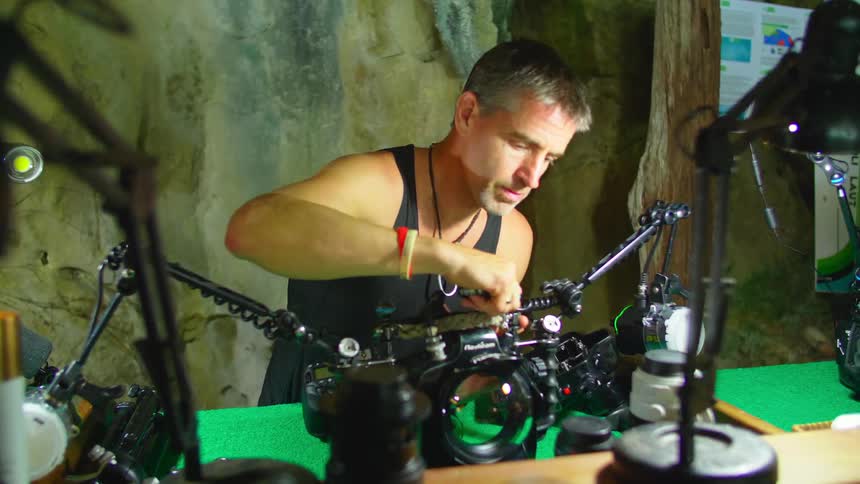 A man works on camera equipment