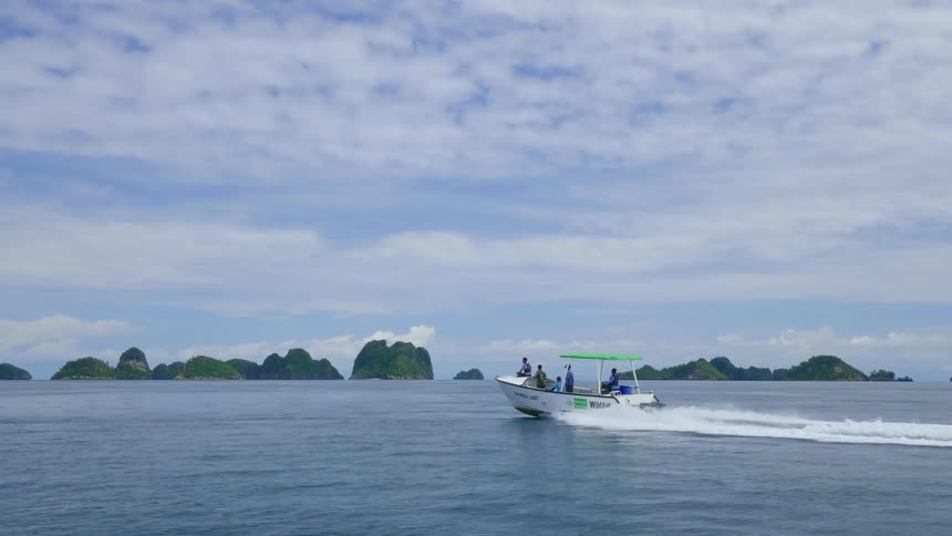 People are driving in a boat during the midday