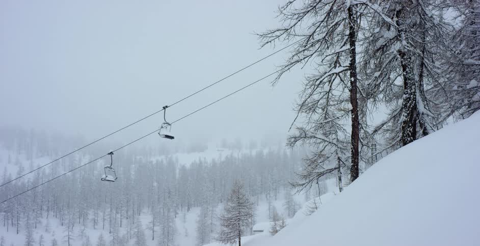 It is snowing on the ski slope