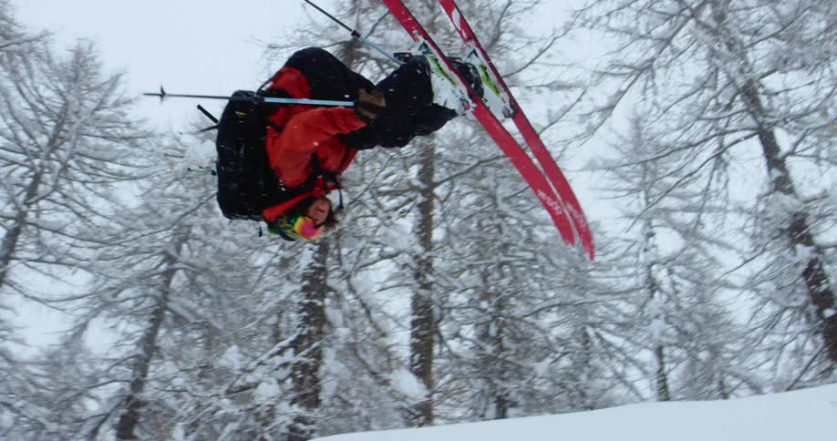 A man is skiing down a mountain in winter
