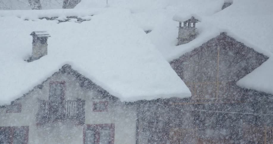 Its snowing in a neighborhood during winter