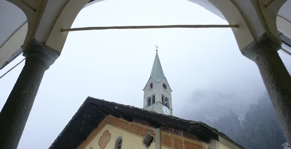 Snow falling over a church