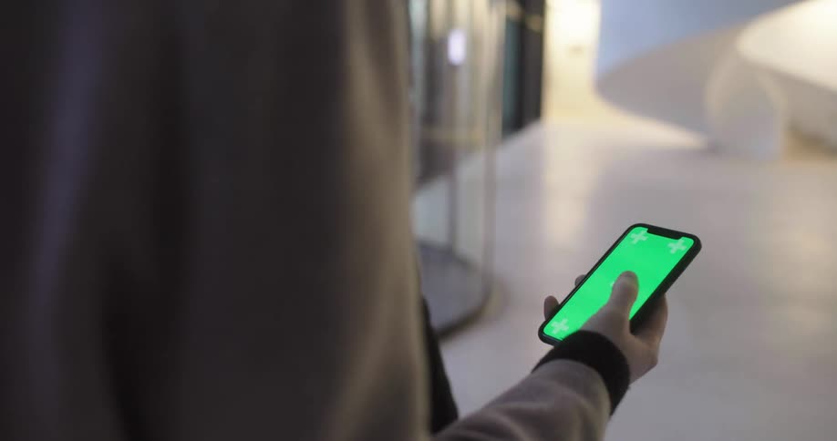 Two people standing with one with a smart phone in their hand