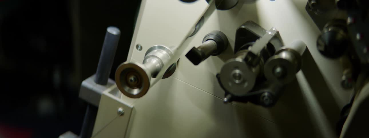 A film projector with film running on wheels
