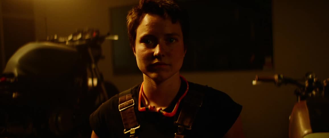 A woman is standing in a room at night