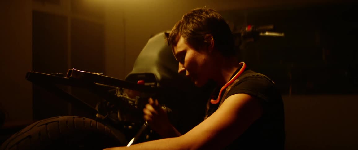A man is working on his motorcycle