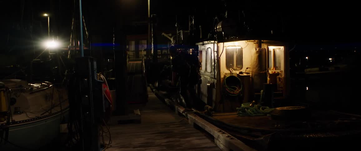 A man with an oxygen tank walking off a boat into a pier