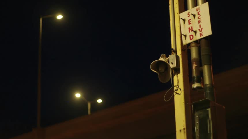 An overpass with streetlights with the sky in the background