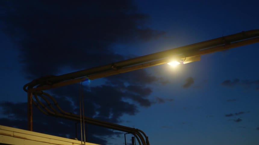 A light fixture shining outside at night