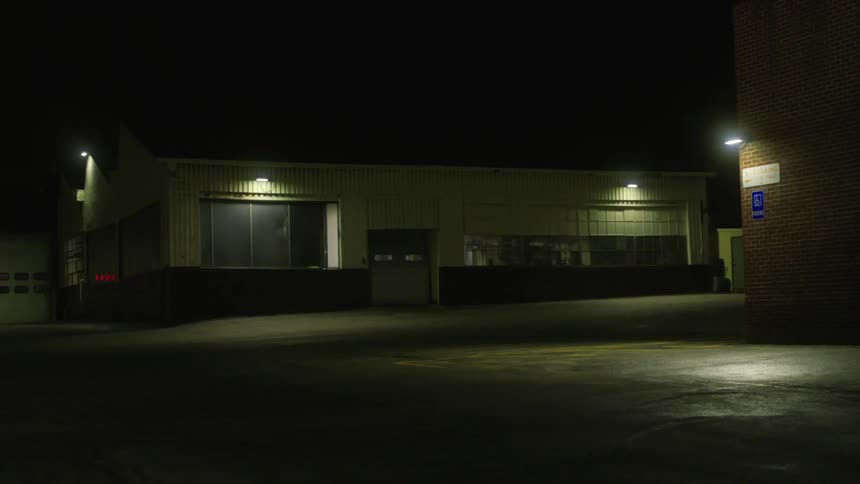 Street lamps illuminate the dark night near town buildings