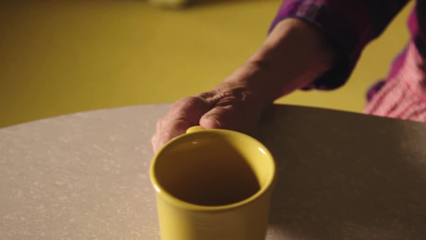 A person is drinking at the table