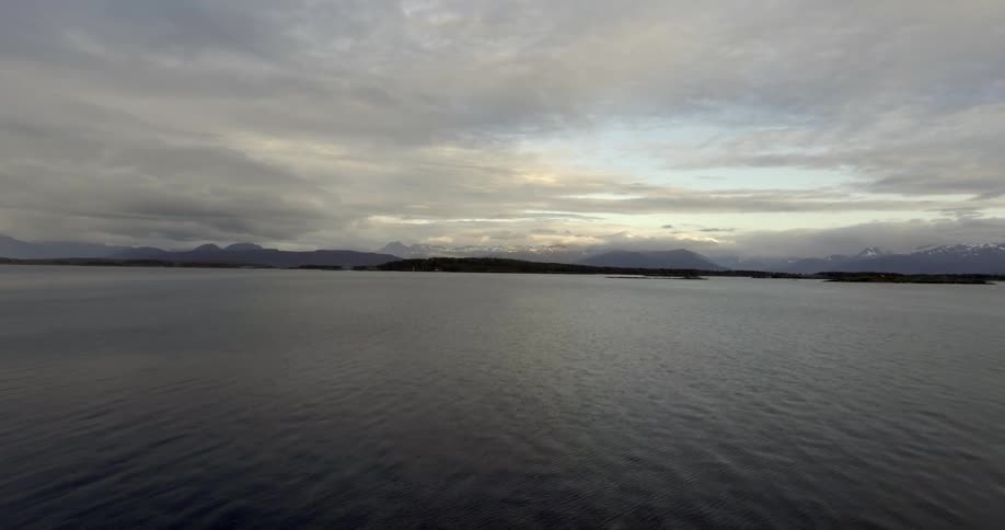 Moving over a large lake at sunset