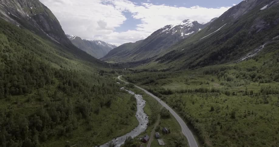 A road and river wind through a mountainous area