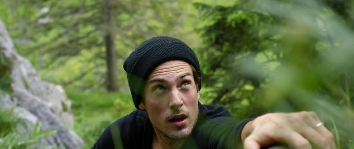 A man is climbing in the wilderness