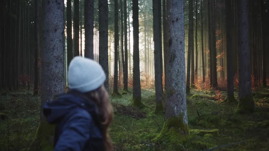 A woman walking through the forest