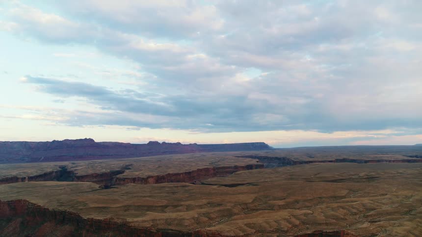A series of canyons under a cloudy daytime sky