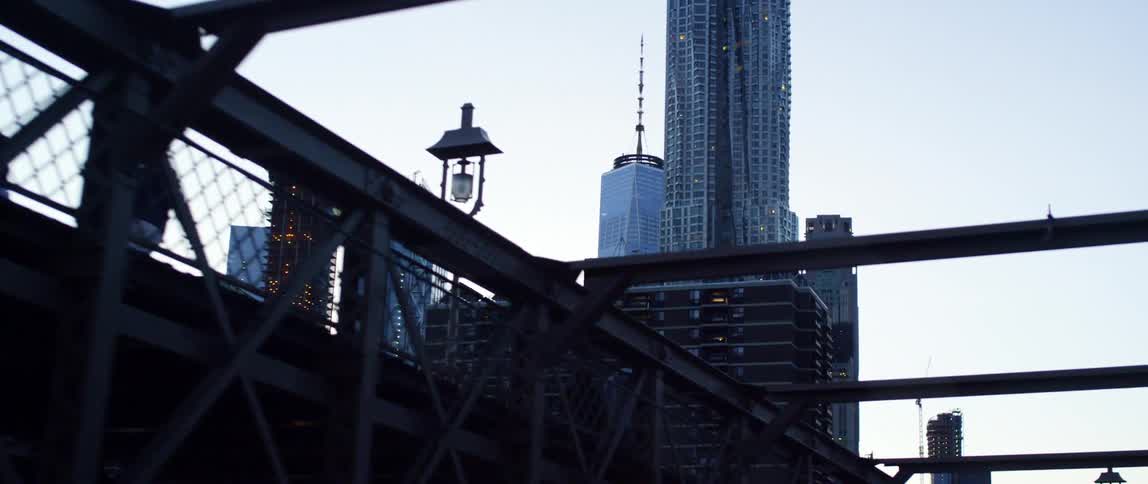 Pedestrians on bridge completely still while camera moves past