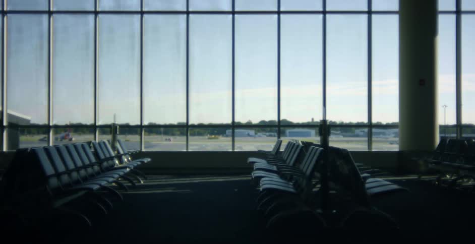 Rows of empty seats in an airplane terminal in the daytime