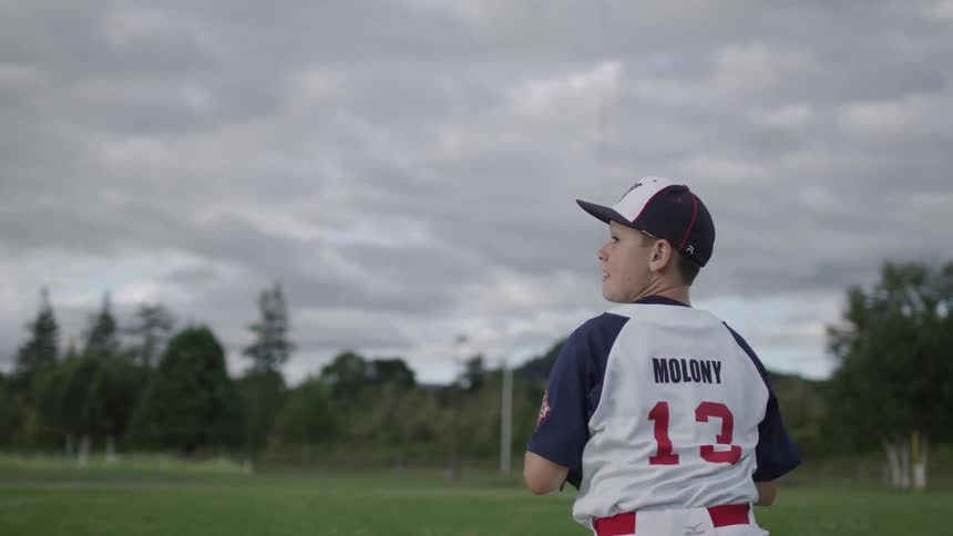 A boy catches a baseball