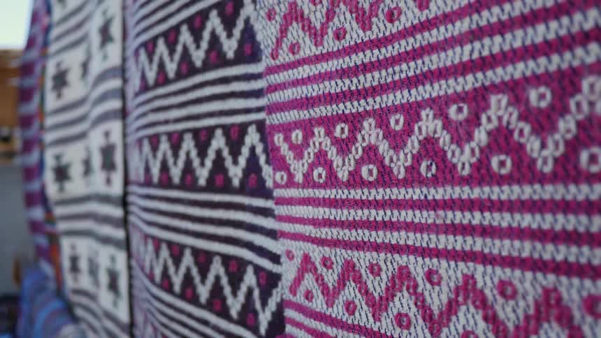 Tight shot of tapestries rustling in the wind